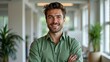 © Beniamin - Smiling young caucasian male in green shirt in bright office with plants