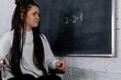 © fotodrobik - A Concerned Student Facing a Challenging Math Problem on the Chalkboard in Class