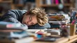 © vanilnilnilla - Exhausted student falls asleep on cluttered desk surrounded by books