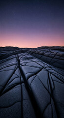 Poster - Dark gray stone texture under a twilight sky, showcasing cracked, geometric patterns. Represents mystery, serenity, and the vastness of nature