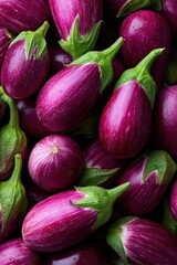 Poster - Fresh and vibrant purple eggplants with green stems arranged in a close-up view showing detailed texture and shiny surface