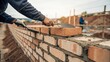© pimpat - Skilled Mason Laying Bricks With Trowel at Construction Site