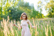 © SergeiPh - A beautiful woman stands in the forest on a summer day. A white dress and transparent panties are dressed on it. The scene is peaceful and serene when the girl is surrounded by nature