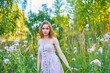 © SergeiPh - A beautiful woman stands in the forest on a summer day. A white dress and transparent panties are dressed on it. The scene is peaceful and serene when the girl is surrounded by nature