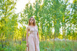 © SergeiPh - A beautiful woman stands in the forest on a summer day. A white dress and transparent panties are dressed on it. The scene is peaceful and serene when the girl is surrounded by nature