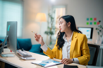 Poster - Businesswoman analyzing marketing document pointing at computer screen working with financial data in office