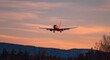© SAYEM - A passenger plane flying in the sky at sunset. The airplane is orange and white, with its wings spread out to show off their black sides. It's about halfway up from ground level.
