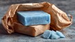 © Irina - Light blue soap bar in kraft paper packaging