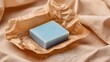 © Irina - Light blue soap bar in kraft paper packaging