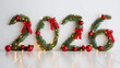 © olgakris - 2026 numbers made of Christmas pine branches with red bows and baubles for New Year winter holiday decoration background