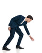© Viorel Sima - side view of handsome young businessman bending and grabbing