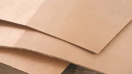 Poster - Brown cardboard sheets for packaging is neatly placed in a stack for further use as background for template pages and banners delivery logistics concept