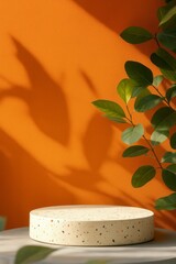 Poster - Empty terrazzo podium on a table illuminated by sunlight with a plant and orange wall background creating a perfect setting for product placement