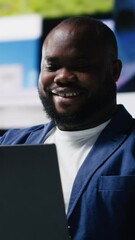 Poster - Vertical Video African american specialist engaging with media dashboards screens, emphasizes networking with AI and technology. Tech driven guy showcases online platforms and internet communication