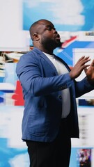 Poster - Vertical Video Confident black public speaker delivers guidance at a live event, presenting digital influence and e commerce at the convention. Social media feeds for web communication. Entertainment
