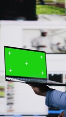 Poster - Vertical Video Professional content creator in a multitasking space holds green screen, leveraging social media, internet big data and cloud systems. Engaging followers to boost digital presence