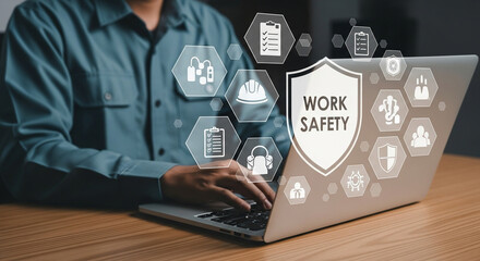 Aufkleber - Person using laptop with work safety shield and icons displayed on screen near the keyboard area