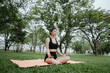© Worawi - A young Asian woman meditates outdoors for peace, mindfulness, and physical well-being. She feels calm, relaxed, and spiritually connected amidst nature.