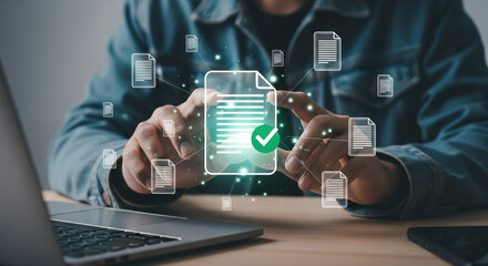 Aufkleber - Man interacting with digital document icons near laptop on a wooden surface at a desk in an office