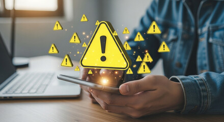 Poster - Person using smartphone with warning signs floating around near laptop on wooden desk surface view