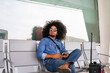 © Koldo_Studio - Stylish young man bored sitting in the waiting area of an airport terminal, holding his smartphone and waiting for his flight