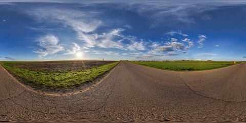 Wall Mural - spherical 360 hdri panorama on old asphalt road with cracks with clouds and sun on blue sky in equirectangular seamless projection, as sky replacement in drone panoramas, skybox game development