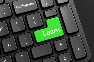 Fototapete - Green learn button on black keyboard technology computer