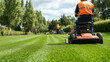 © AGCreative - Professional landscaping crew mowing public park in vibrant green space, showcasing precision and teamwork in maintaining beauty of nature
