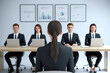 © Rsquare stock - A female job applicant facing an interview panel of four professionals in a modern corporate Office. job interview, female applicant, interview panel, hiring process, recruitment, formal interview