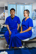 © Westend61 - Two nurses in blue scrubs sitting in a hospital room after work, socializing and relaxing.