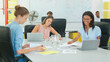 © Monkey Business - Three Young Businesswomen Working Around Table With Laptops And Documents