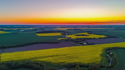 Wall Mural - colorful plains against sunset sky during springtime. aerial drone shot