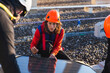 © ADDICTIVE STOCK - Rooftop solar panel installation by focused workers