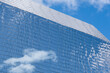 © Anchalee - Glass building with blue sky,cloud background,Modern high rise office buildings and residential towers with reflective glass facades, Fragments multi storey office and residential buildings in City