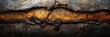 © Nice Seven - Close-up image of cracked, textured earth with a reddish-brown layer, showing natural soil erosion and rugged terrain details.