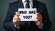 © Satou Akira - Businessman Holding Who Are You Sign Identity Question