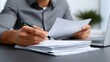 © pkproject - A person reviewing important business documents at their desk.
