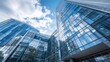 © artbot - Modern glass office buildings under a partly cloudy sky