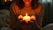 © Satou Akira - Woman Holding Lit Candle in Hands Peaceful Moment