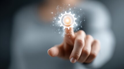 Poster - A person is reaching out to touch a glowing gear icon that represents technology and innovation. The background is blurred, focusing on the digital interaction.