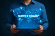 © Pixel Studio - Person holding tablet displaying a glowing world map with supply chain connections overlayed on it