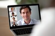 © Chandlerlikes - Video call meeting between remote coworkers displayed on a laptop screen with diverse faces