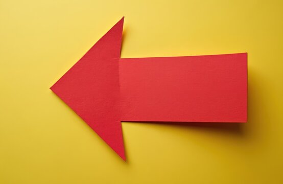 Red arrow on yellow background. Paper arrow sign, direction, pointing. Signage for direction. Conceptual message with copy space. Symbol of choice, way. Business, marketing, navigation, guidance,
