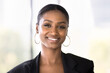 © fizkes - Beauty and charisma. Head shot portrait attractive smiling young African American businesswoman professional specialist expert looking at camera feel confident successful motivated in career and life