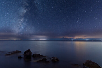 Canvas Print - beautiful night landscape , lake and stones starry sky with milky way galaxy.