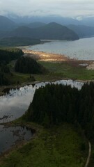 Wall Mural - Aerial View of a Serene Lake and Forested Mountains Reflecting the Sky in British Columbia, Canada