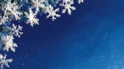Wall Mural - Snowflakes delicately rest on pine branches against a deep blue winter sky, capturing the serene beauty of a snowy day.