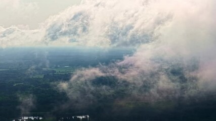 Wall Mural - Fluffy clouds and Latvian landscape, high altitude aerial view