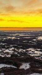 Wall Mural - Orange Skies Over Snowy Landscape In Winter At Dusk. - vertical, timelapse shot