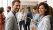 © Ariestia - Group of happy business people networking at a conference.